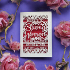 A cut out Mother's Day Card that says "Here's to Strong Women, may we know them, may we be them, may we raise them"