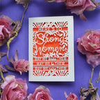 A laser cut International Women's Day Card that says "Here's to Strong Women, may we know them, may we be them, may we raise them"