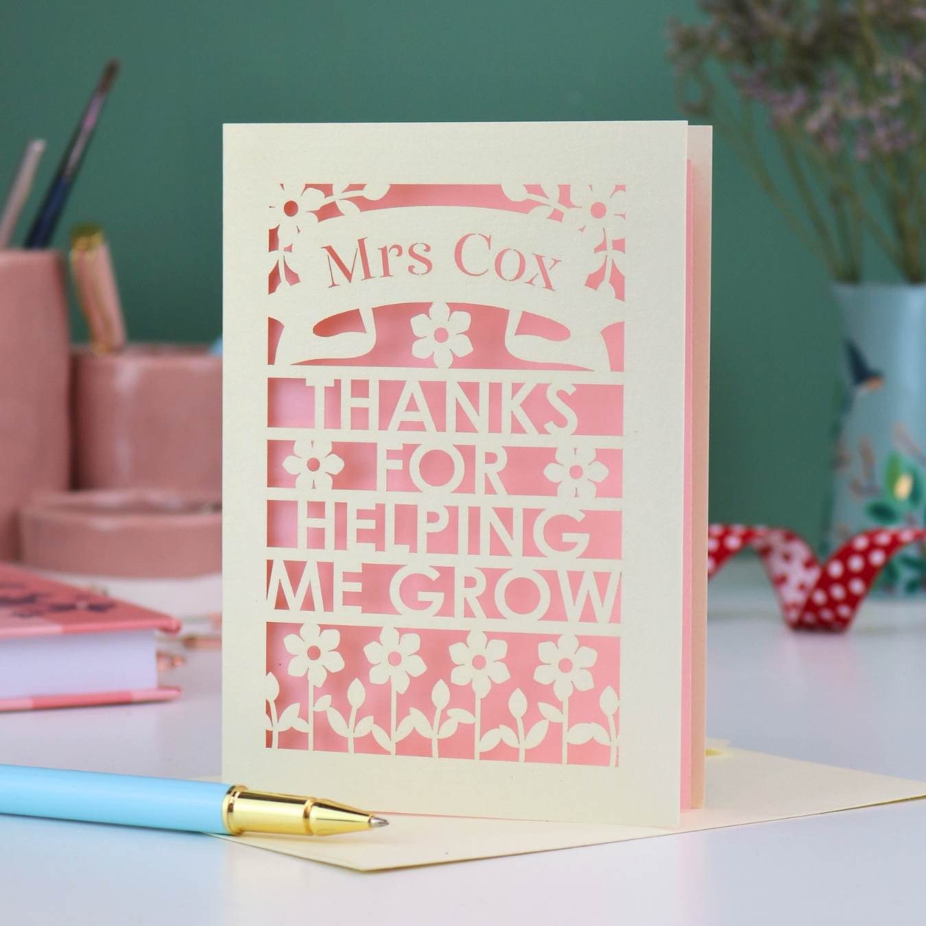 A cut out thank you teacher card with personalised text "Mrs Cox, Thanks for Helping me Grow"