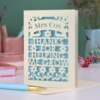 A keepsake thank you teacher card with personalised text "Mrs Cox, Thanks for Helping me Grow"