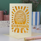 A laser cut thank you teacher card with rosette design and the words "Best teacher ever" in the centre of the rosette, personalised with the teacher's name underneath