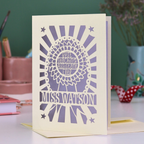 A personalised thank you teaching assistant card with cut out rosette design and text "Best Teaching Assistant Ever" and personalised with the name "Miss Watson"