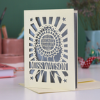 A laser cut thank you teaching assistant card with cut out rosette design and text "Best Teaching Assistant Ever" and personalised with the name "Miss Watson"