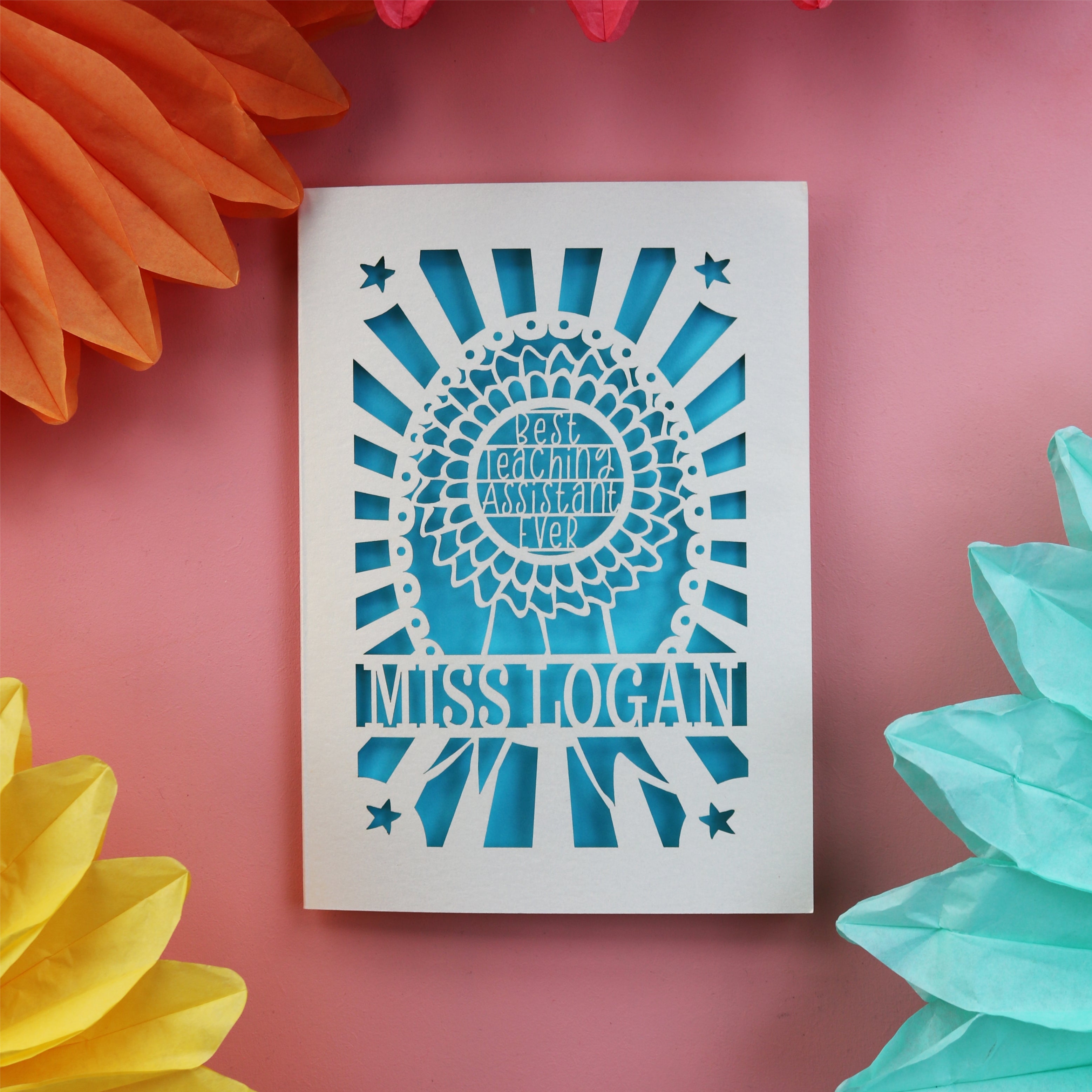 A cute thank you teacher card for a teaching assistant. Card has a rosette with "Best teaching assistant ever" and is personalised with their name