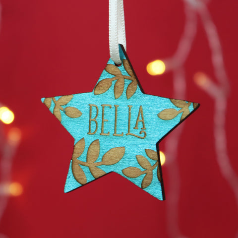 Personalised Christmas decoration, engraved with a name and hand painted teal.