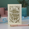 Personalised Laser-cut 'Thank you' card with decorative elements on a table with stationery items.