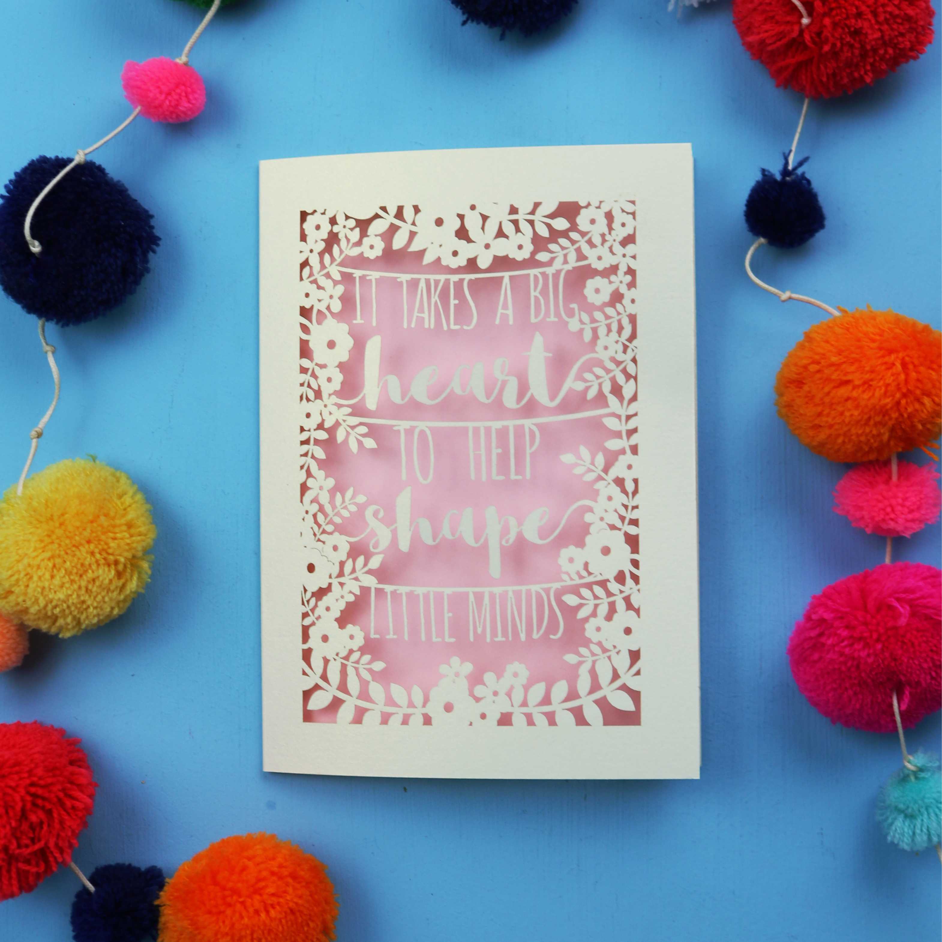 Unique Thank you teacher card with motivational quote surrounded by colourful pom-poms on a blue background
