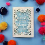 Handmade Thank you teacher card with motivational quote surrounded by colourful pom-poms on a blue background