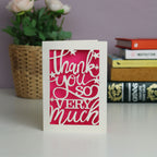 Papercut "Thank you so very much"  card with stars. Shocking pink background and cream card.