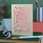 Thank you Mum laser cut mother's day Card with floral design and text on a desk with stationery items