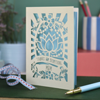 Thank you Mum laser cut mother's day Card with floral design and text on a desk with stationery items