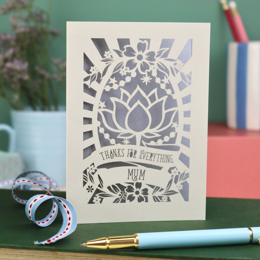 Thank you Mum laser cut mother's day Card with floral design and text on a desk with stationery items
