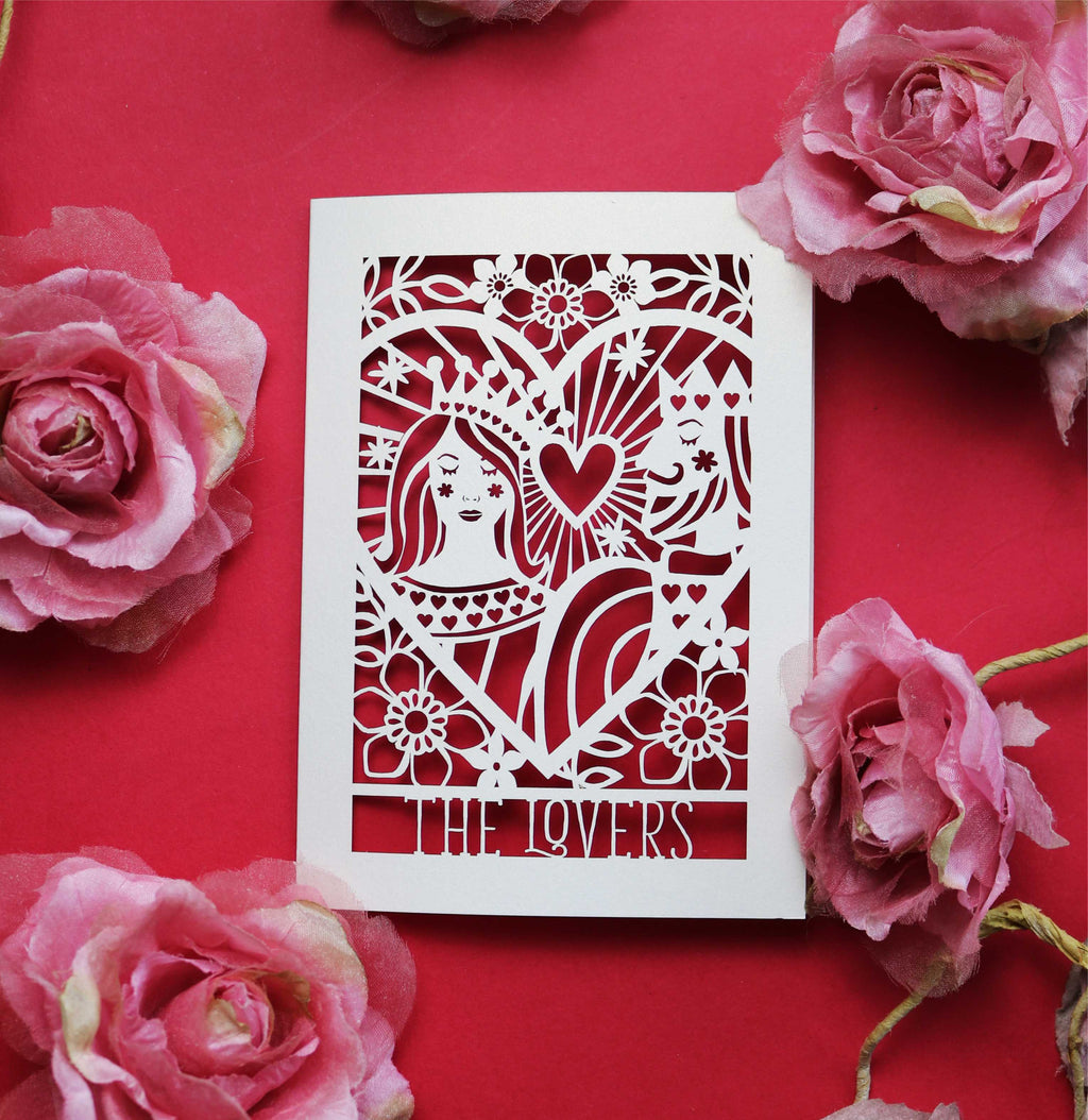 A cut out wedding card featuring an illustration inspired by the lovers tarot card