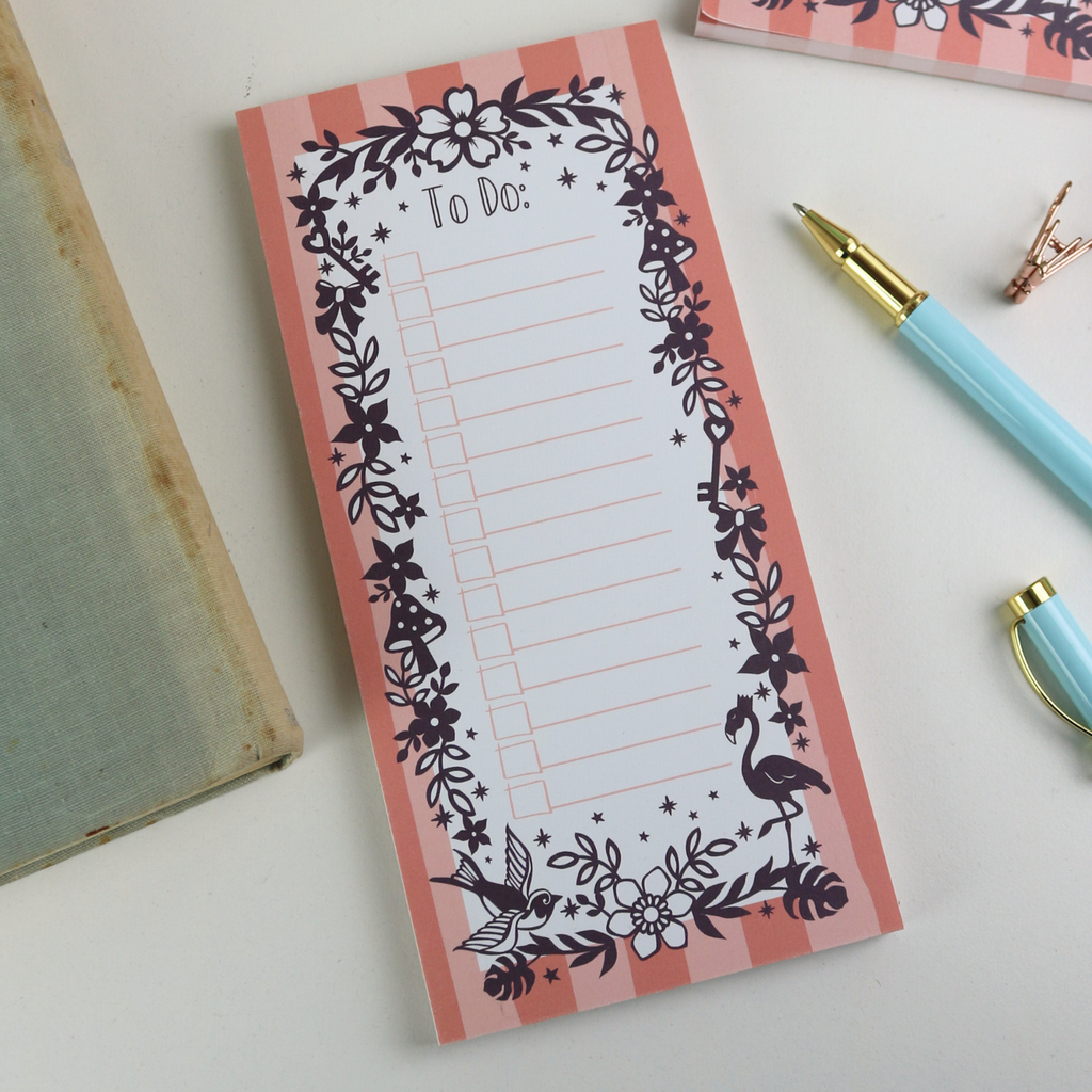 A notepad with pink striped border and purple floral illustrations, with "To Do:" at the top and lines with check boxes