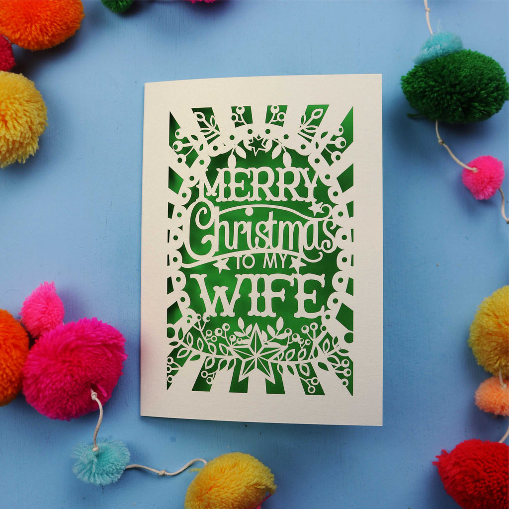 Wife Christmas card with 'Merry Christmas to my Wife' text on a blue background with colourful pom-poms.