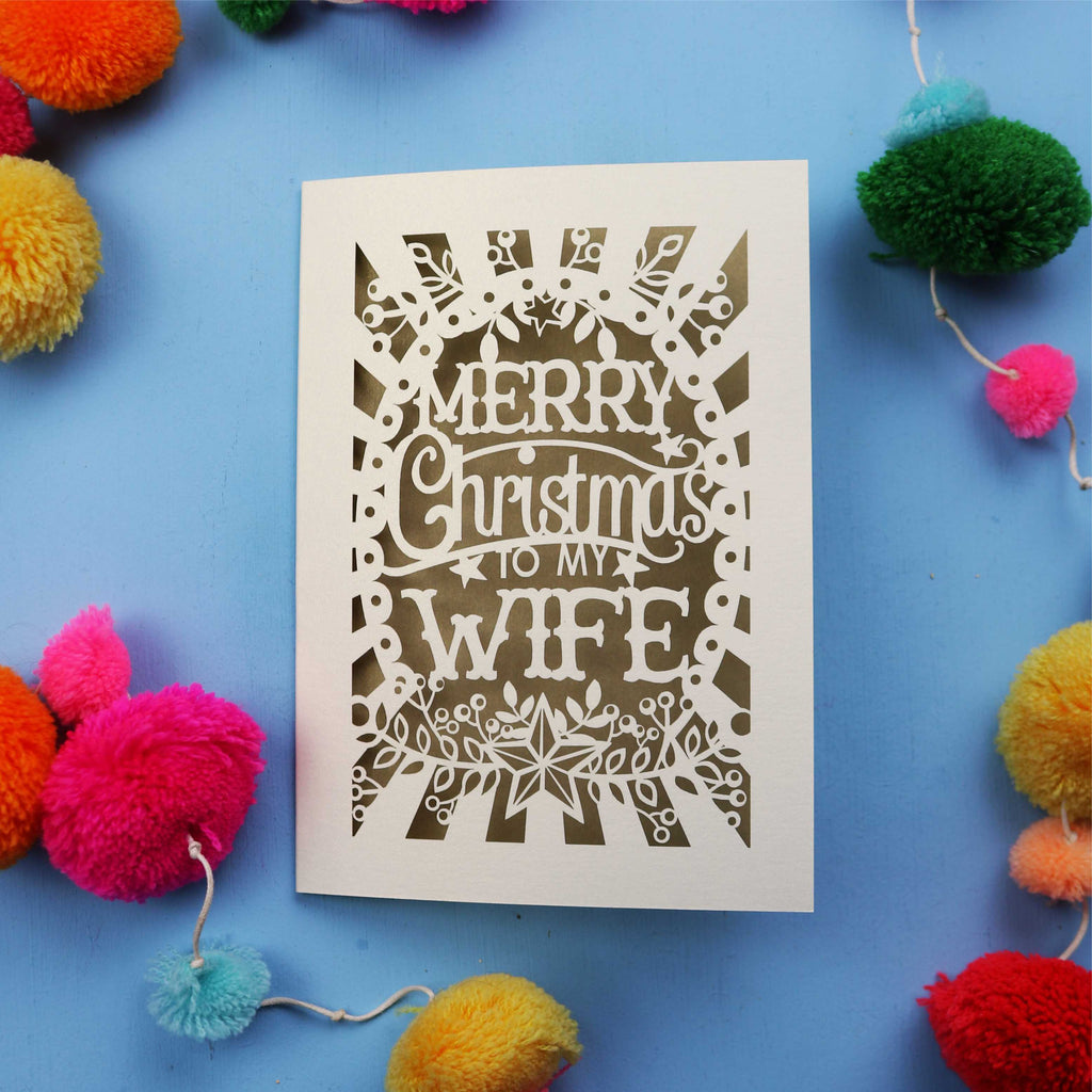 Wife Christmas card with 'Merry Christmas to my Wife' text on a blue background with colourful pom-poms.