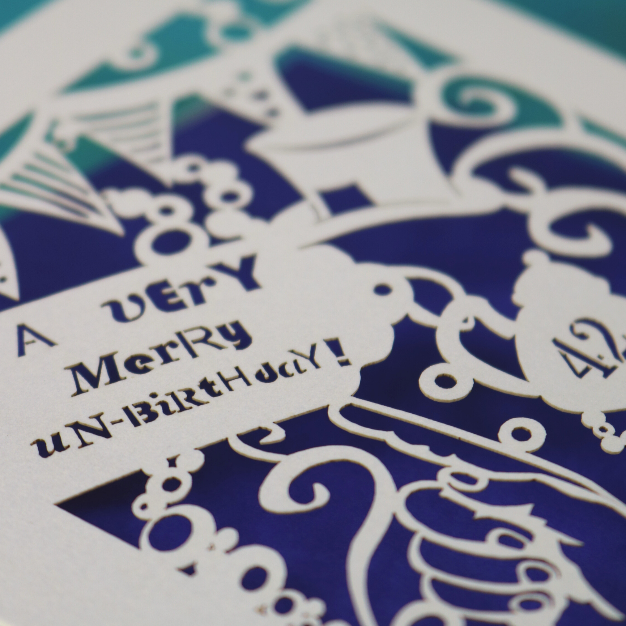 Decorative birthday card with intricate cut-out patterns and text.