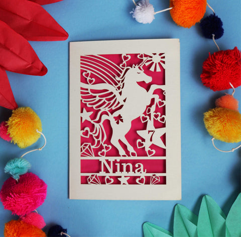 A personalised laser cut birthday card with a unicorn on it