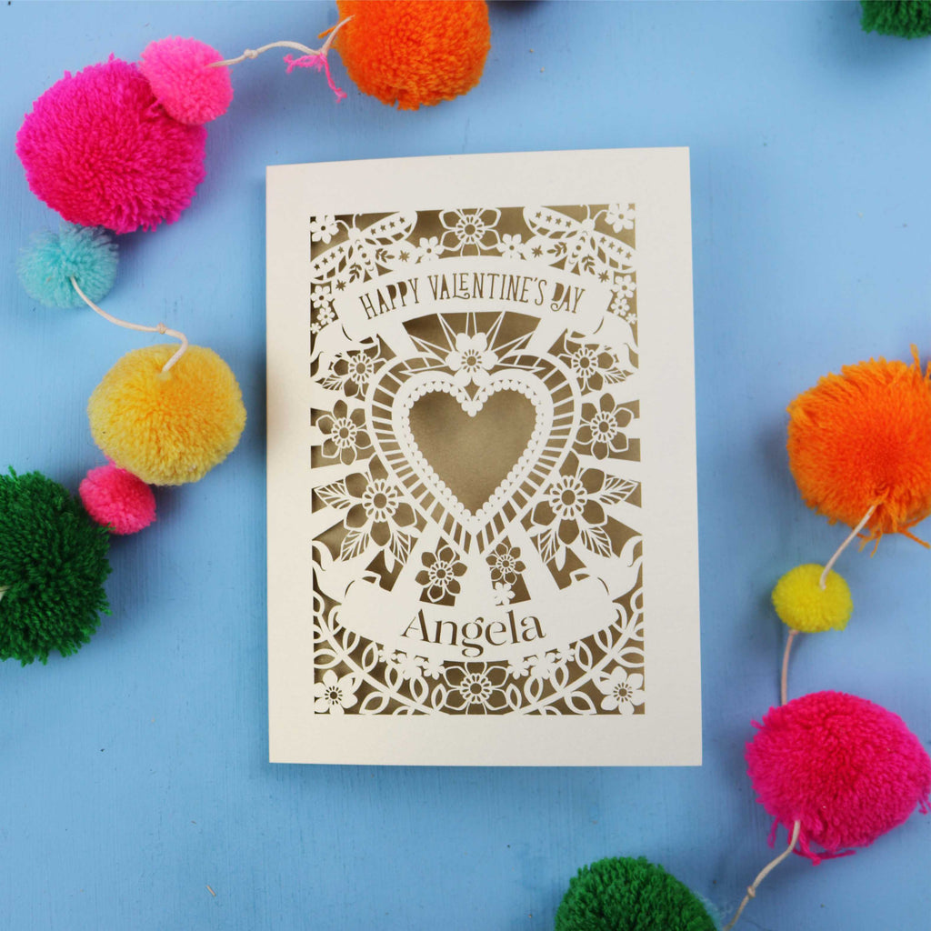 Laser-cut Valentine's Day card with decorative elements on a blue background