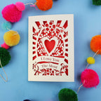 Valentines Card with 'I Love You The Most' design on a blue background with colourful pom-poms.
