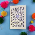 Luxury Valentines Card with 'I Love You The Most' design on a blue background with colourful pom-poms.