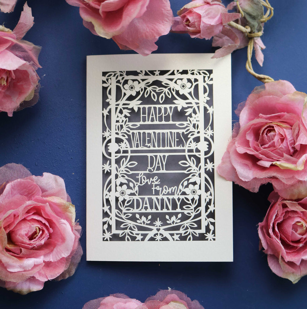 A personalised Valentine's card, laser cut with a floral and star border and the words "Happy Valentine's Day, Love from NAME"