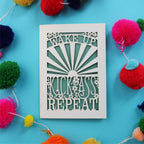 A cut out motivational card that says "Wake up, Kick ass, repeat"