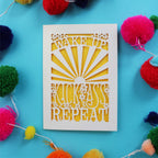 A laser cut good luck card that says "Wake up, Kick ass, repeat"