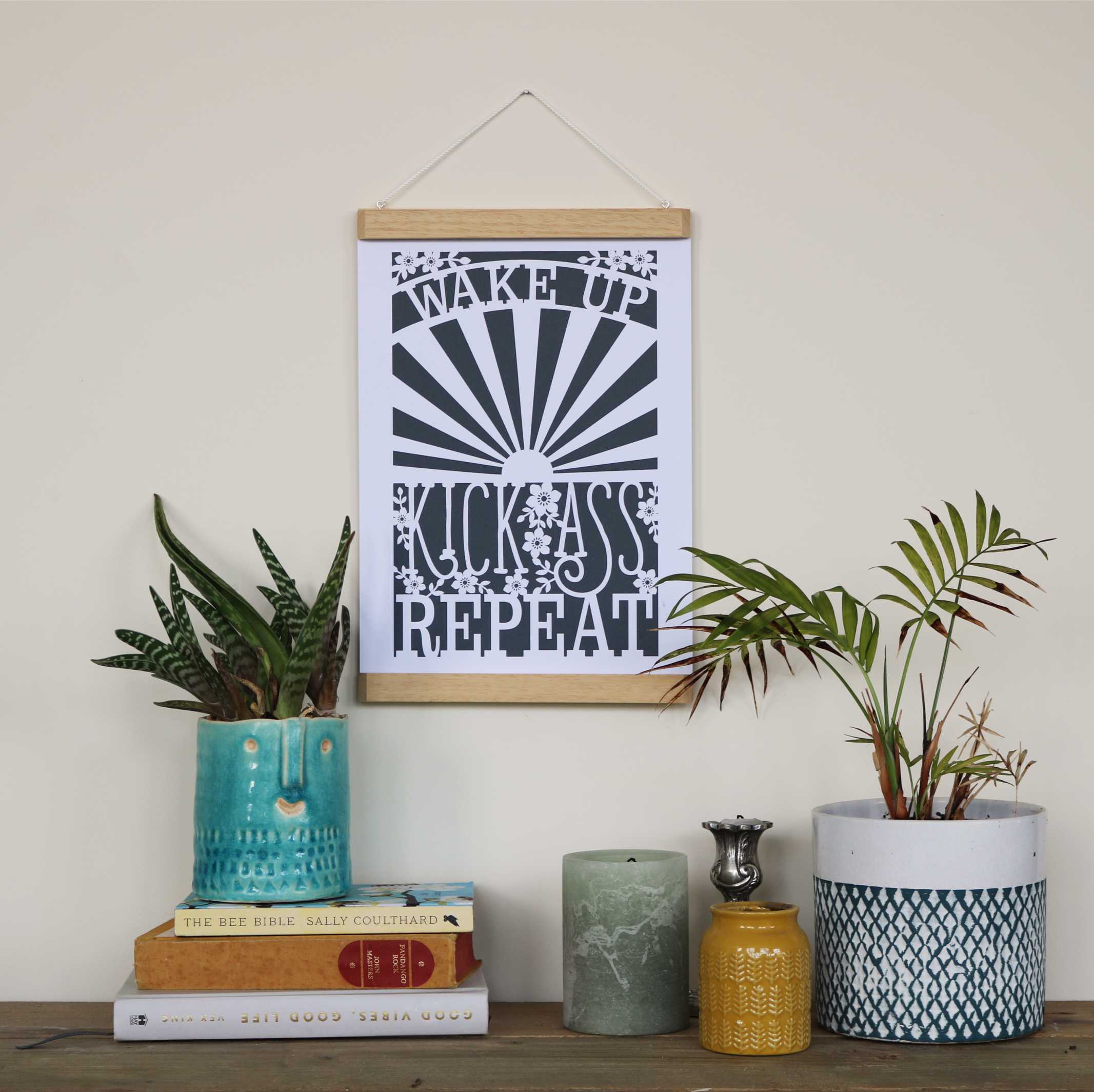 A motivational quote print in a wooden magnetic poster frame