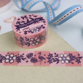 Decorative washi tape with floral and flamingo design on a pink background