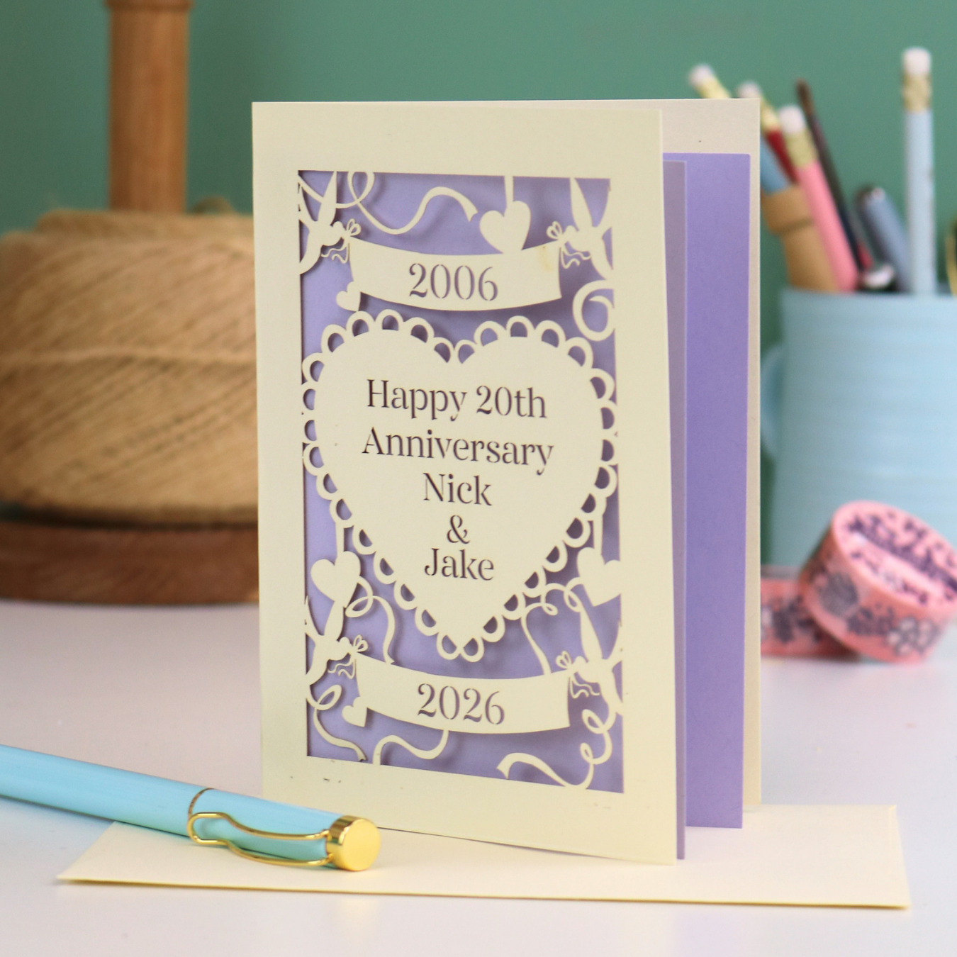 Personalized 20th anniversary card with decorative elements on a table.
