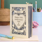 Personalized 20th anniversary card with decorative elements on a table.