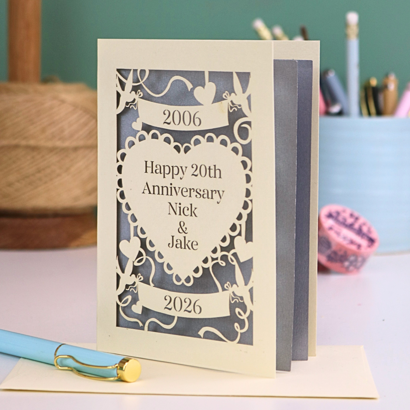 Personalized 20th anniversary card with decorative elements on a table.