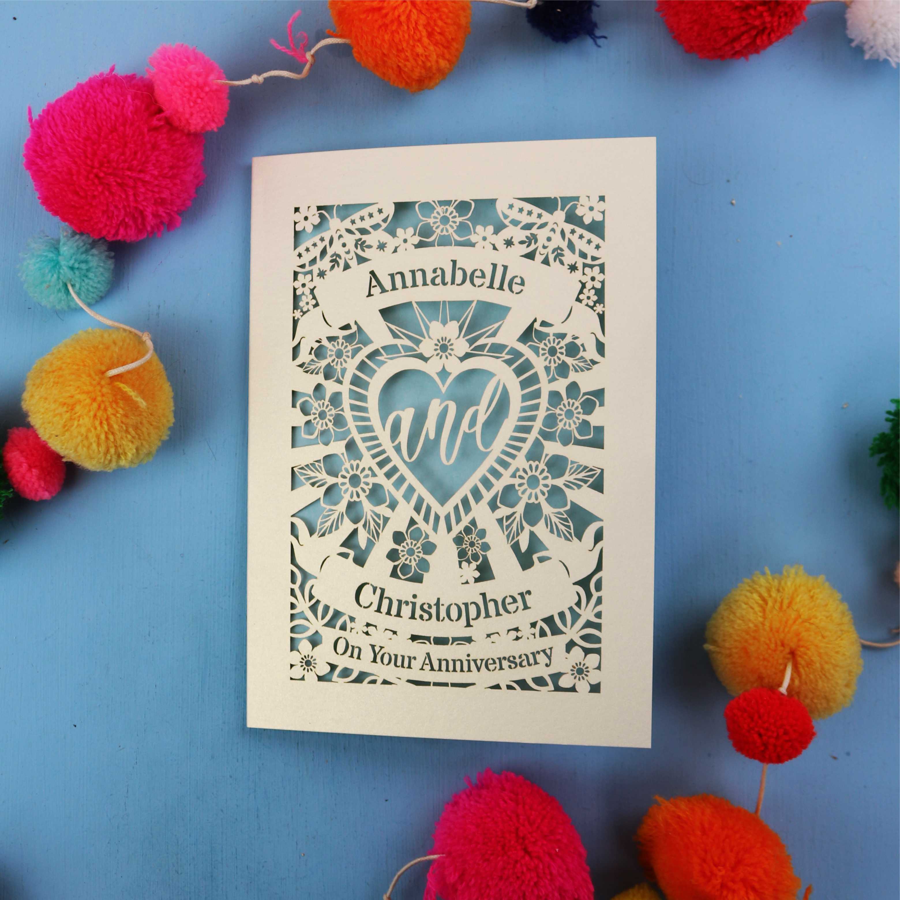 Personalised laser cut anniversary card with decorative elements on a blue background