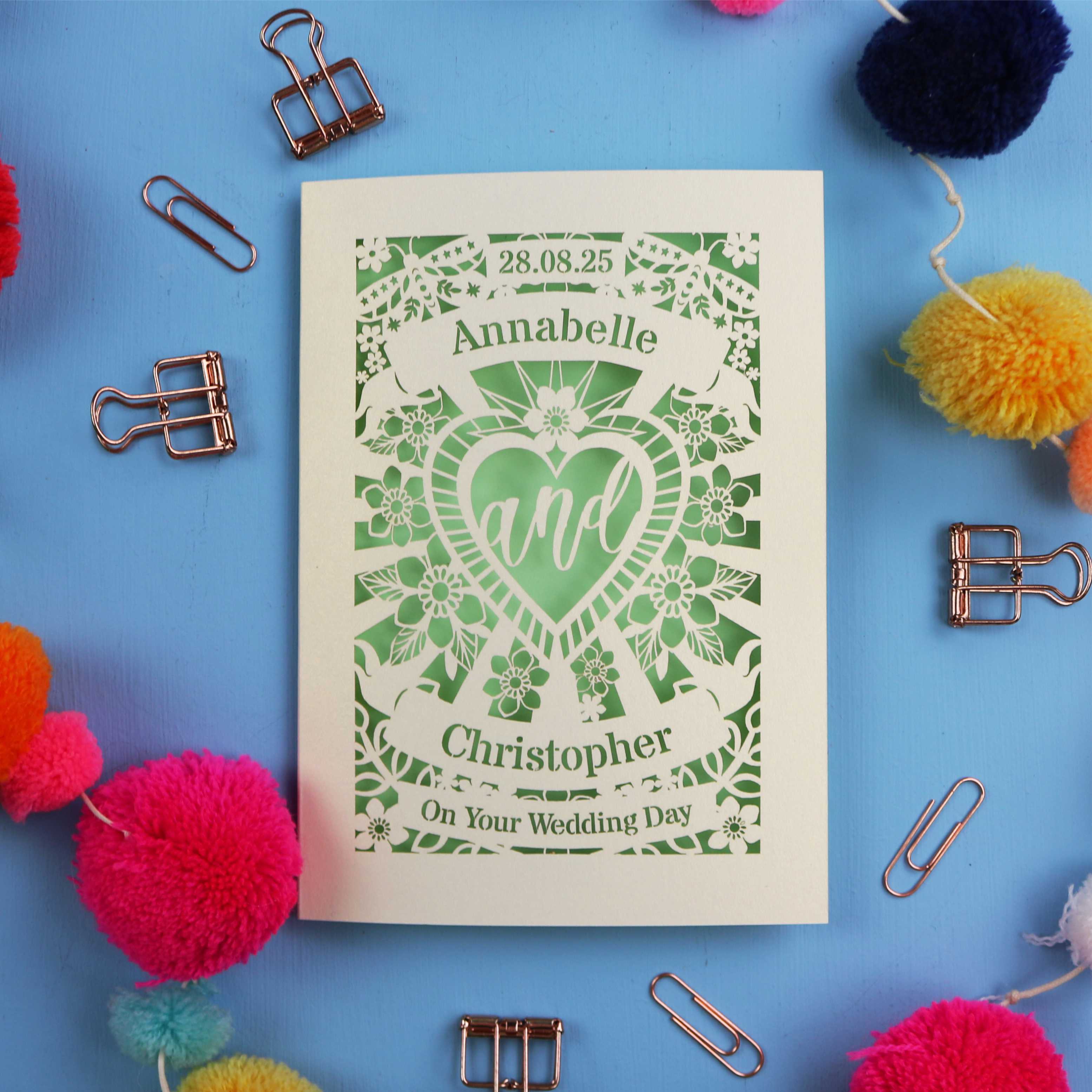 Personalized wedding card with decorative elements on a blue background