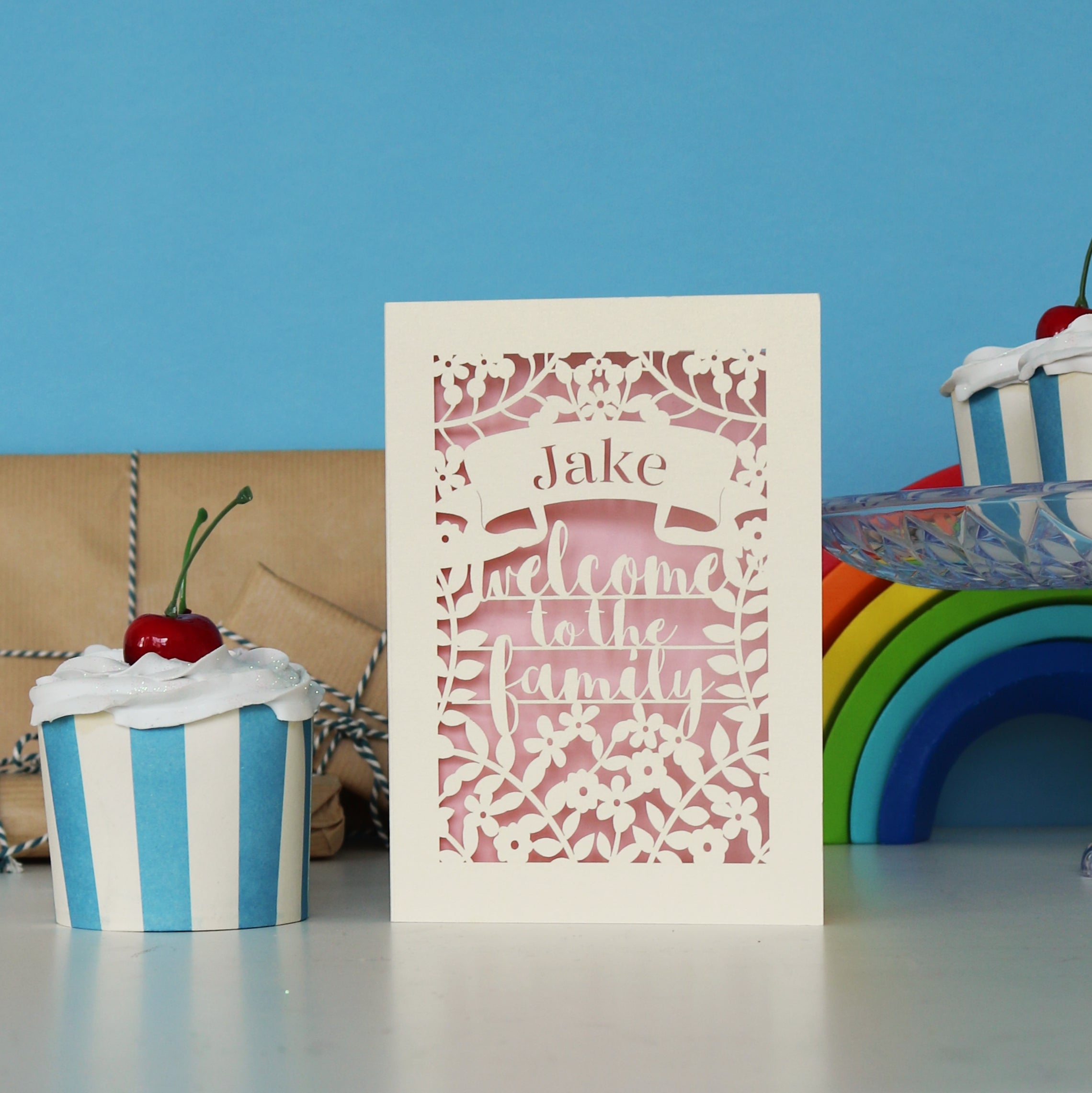 A laser cut card that says Welcome to the Family