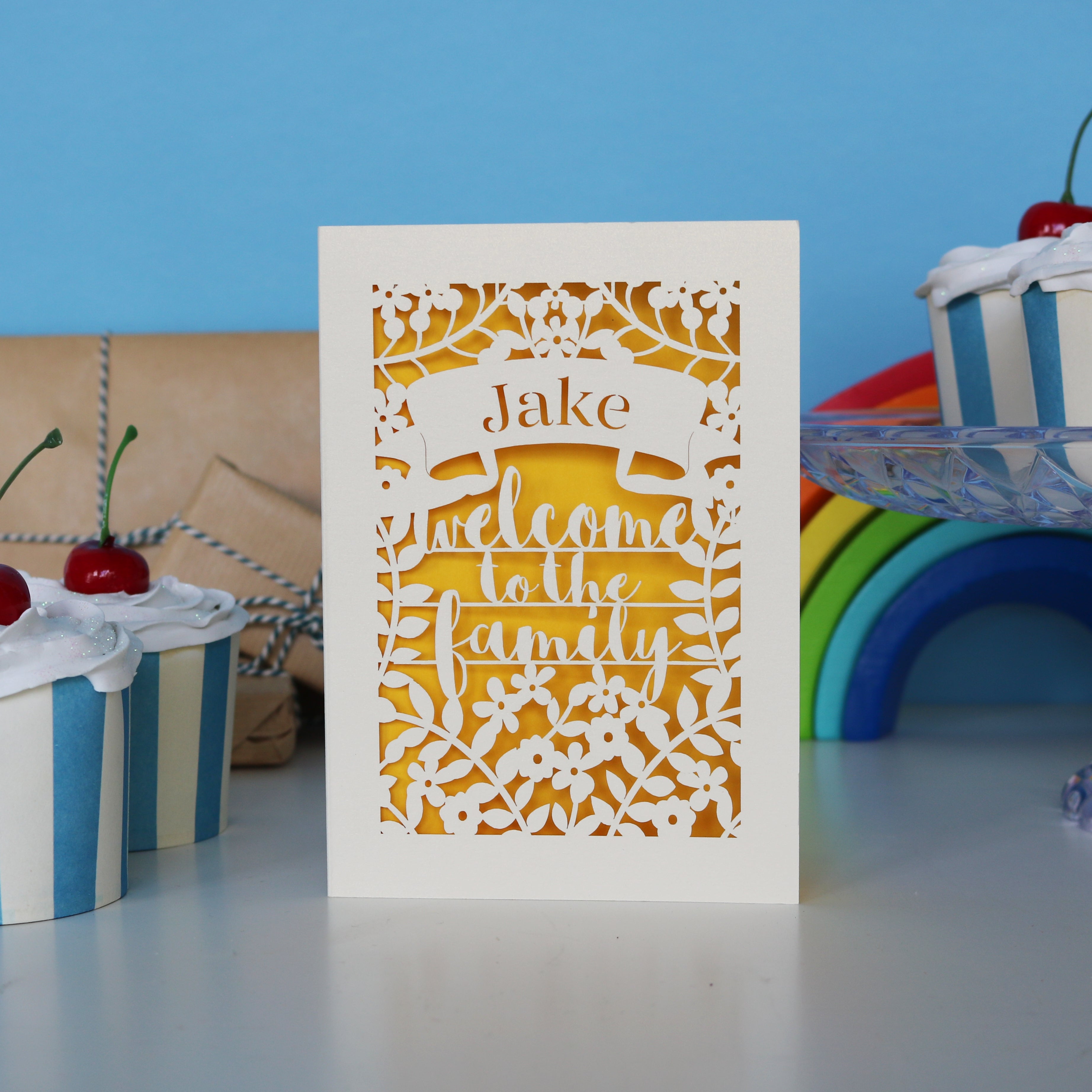 A laser cut card that says Welcome to the Family"