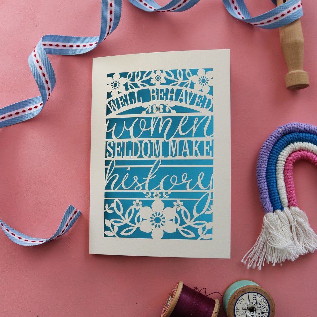 A cut out card for rebel girls. Card says "Well behaved women seldom make history"