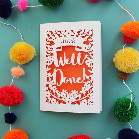 A personalised graduation card that says "Well Done" and has the recipient's name in a banner - A5 / Orange