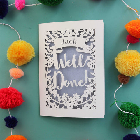 A personalised laser cut celebration card that says "Well Done" and has the recipient's name in a banner - A5 / Silver