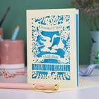 Personalised Welsh New Baby card with stork design and text: "Croeso I'r Byd", personalised with the date of birth and baby's name, on a blurred background