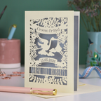 Personalized laser-cut Welsh New Baby card with stork design and text: "Croeso I'r Byd", personalised with the date of birth and baby's name, on a blurred background