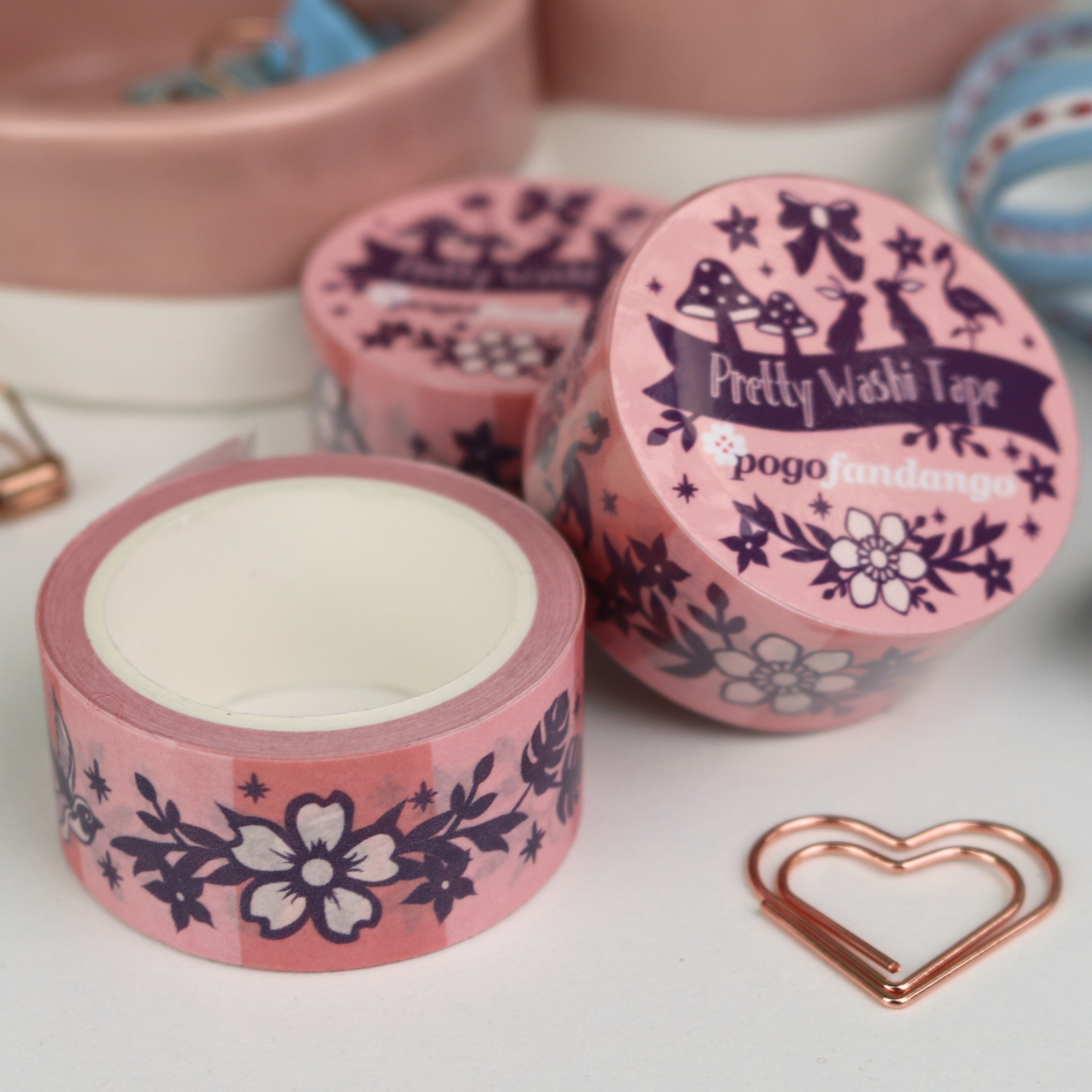 Pink washi tape with decorative designs and 'pogofandango' branding on a white surface.
