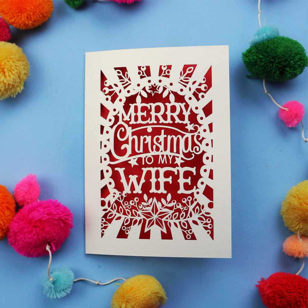 Wife Christmas card with 'Merry Christmas to my Wife' text on a blue background with colourful pom-poms.