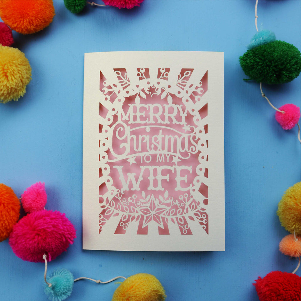 Wife Christmas card with 'Merry Christmas to my Wife' text on a blue background with colourful pom-poms.