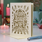A laser cut wife Christmas card in cream with decorative cut out text, 'Merry Christmas to my Wife'