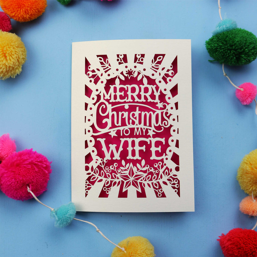 Wife Christmas card with 'Merry Christmas to my Wife' text on a blue background with colourful pom-poms.