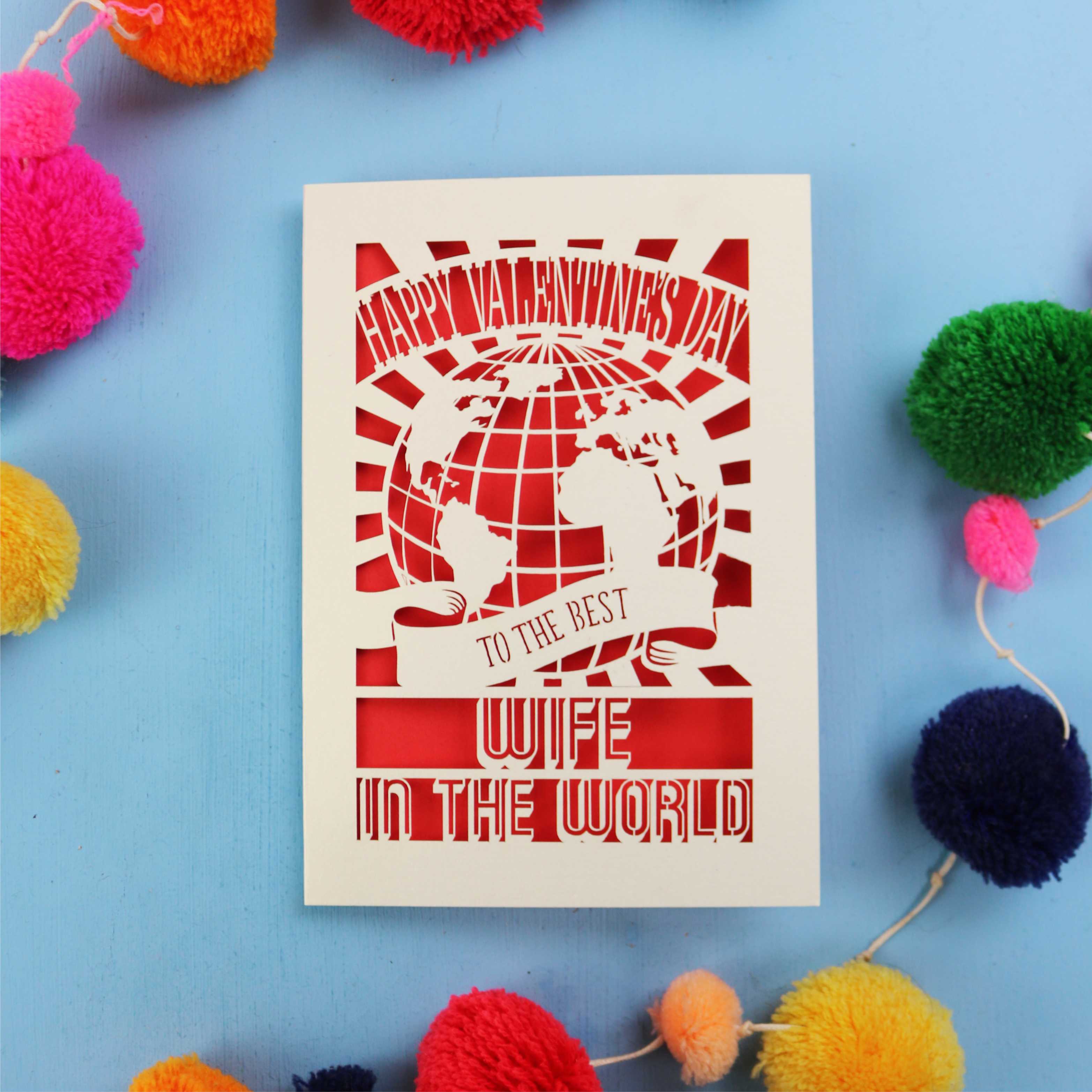 A Wife Valentine's Day card for the best wife in the world with colourful pom-poms on a blue background