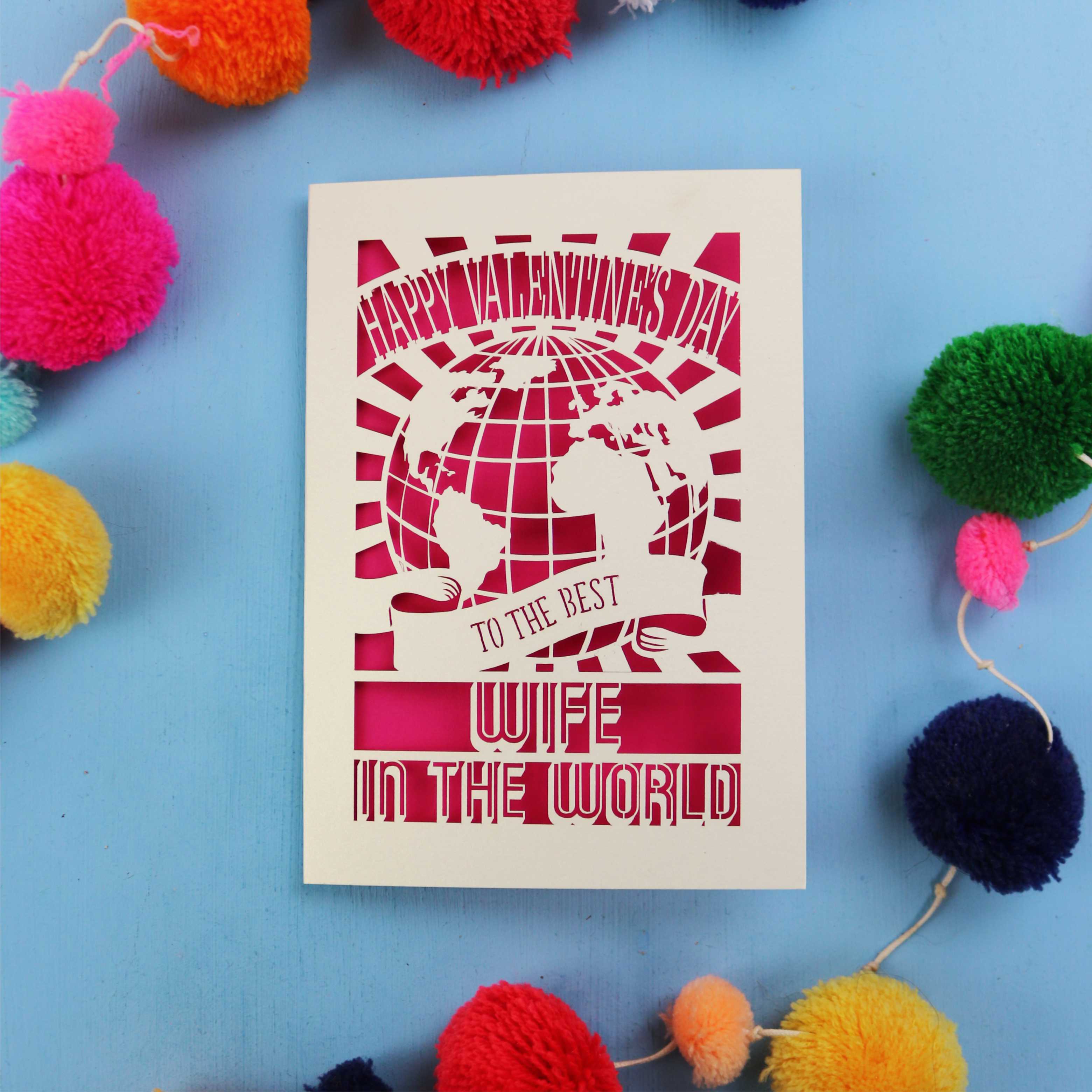 A Wife Valentine's Day card for the best wife in the world with colourful pom-poms on a blue background
