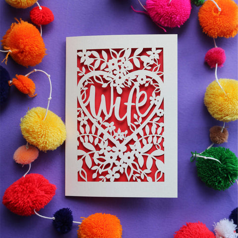 A laser cut card that has the word "Wife" on it.
